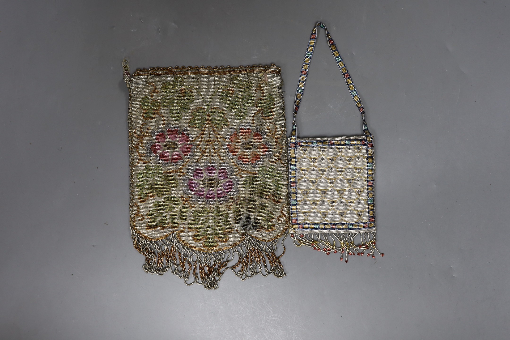 A fine multicoloured metal beaded bag, with shaped tasselled edge and a smaller similar worked purse with abstract design, both 1900-1920